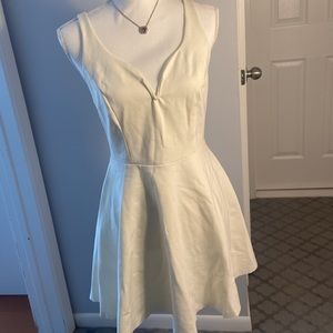 White zip up skirted short dress.